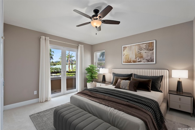 carpeted bedroom featuring baseboards, access to outside, and a ceiling fan