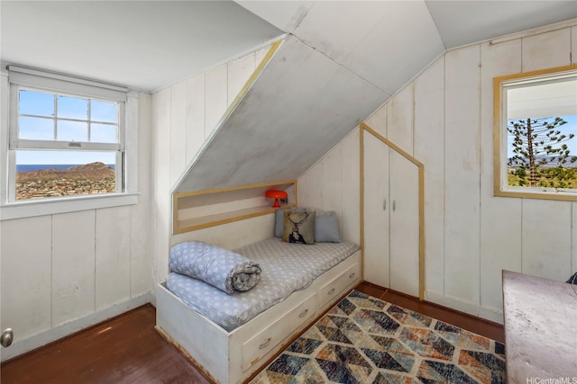 3637 Nihipali Pl, Honolulu, HI 96816 - bedroom featuring wood finished floors, lofted ceiling, and a decorative wall
