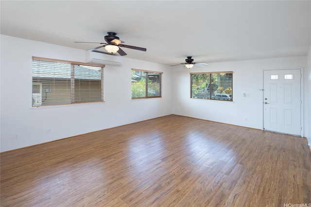 92-1199 Pueonani St, Kapolei, HI 96707 - empty room featuring a ceiling fan, wood finished floors, and a wall mounted air conditioner