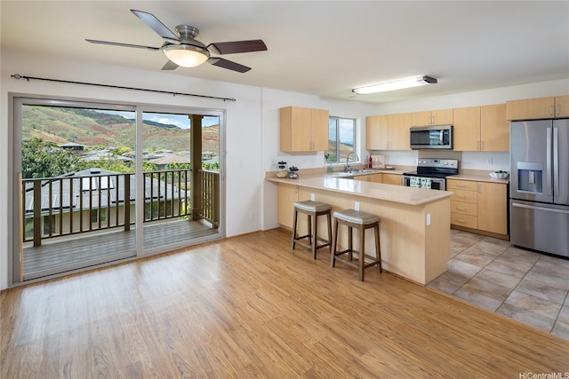 92-1199 Pueonani St, Kapolei, HI 96707 - kitchen featuring appliances with stainless steel finishes, light brown cabinetry, a sink, and light countertops