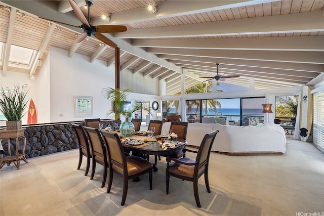 carpeted dining space featuring a ceiling fan and lofted ceiling with beams