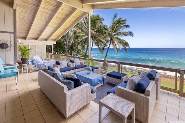 view of patio / terrace featuring a water view, a view of the beach, and an outdoor hangout area