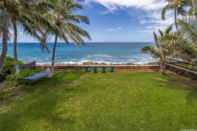 water view featuring a beach view and fence
