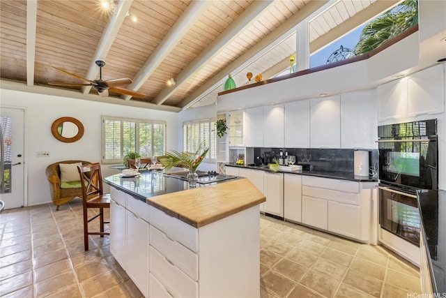 kitchen with butcher block countertops, backsplash, wooden ceiling, and beam ceiling