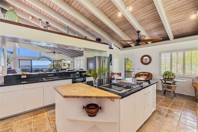 kitchen featuring ceiling fan, a sink, open shelves, and black electric cooktop