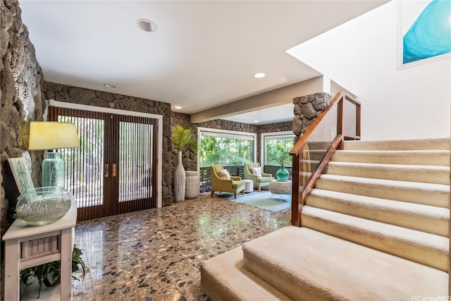 entryway with recessed lighting, stairs, and french doors