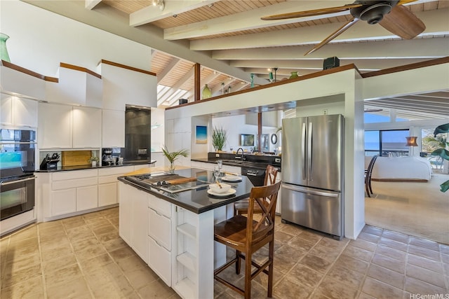 kitchen featuring dark countertops, ceiling fan, black appliances, and lofted ceiling with beams