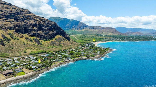 birds eye view of property with a water and mountain view