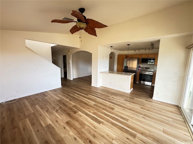 unfurnished living room with arched walkways, a ceiling fan, visible vents, and light wood finished floors