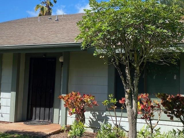 exterior space featuring roof with shingles and covered porch