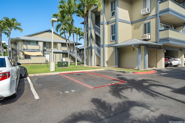 uncovered parking lot featuring cooling unit