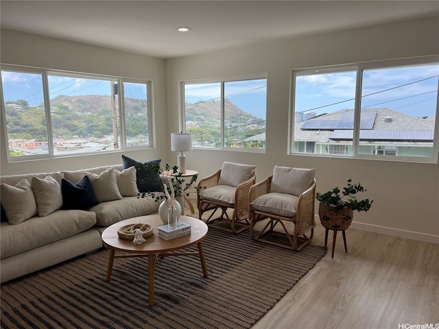living room with recessed lighting, light wood-style floors, and baseboards
