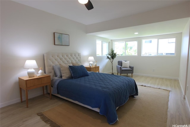 bedroom featuring baseboards, a ceiling fan, and wood finished floors