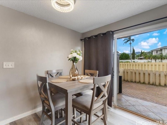 94-546 Kupuohi St Unit 104, Waipahu, HI 96797 - dining space with a textured ceiling and light wood-type flooring