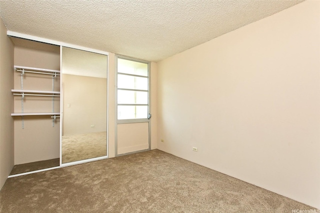 3161 Ala Ilima St Unit 1515, Honolulu, HI 96818 - unfurnished bedroom featuring a textured ceiling, carpet, and a closet