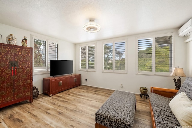 2168 Round Top Dr, Honolulu, HI 96822 - living room featuring a wall mounted AC, light wood-style flooring, and baseboards