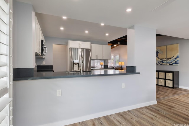 914 Lemiwai St, Wahiawa, HI 96786 - kitchen featuring appliances with stainless steel finishes, a peninsula, wood finished floors, dark countertops, and recessed lighting