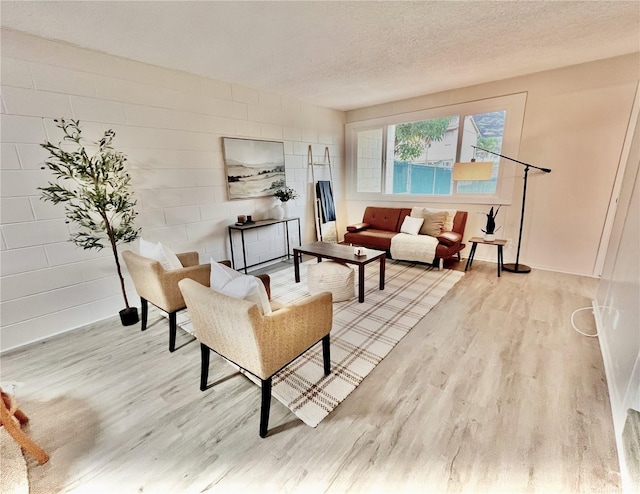 85-114 Ala Walua St Unit F, Waianae, HI 96792 - living room featuring wood finished floors, baseboards, and a textured ceiling