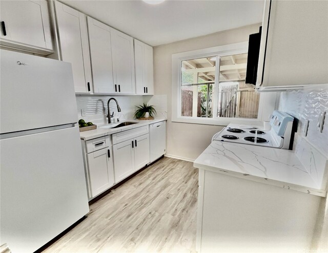 85-114 Ala Walua St Unit F, Waianae, HI 96792 - kitchen featuring white appliances, a sink, light wood finished floors, and white cabinets