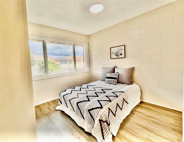 85-114 Ala Walua St Unit F, Waianae, HI 96792 - bedroom with wood finished floors, a textured ceiling, and baseboards