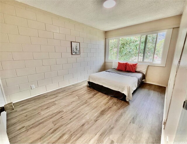 85-114 Ala Walua St Unit F, Waianae, HI 96792 - bedroom featuring wood finished floors and a textured ceiling
