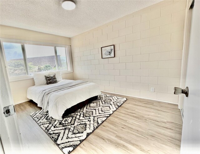 85-114 Ala Walua St Unit F, Waianae, HI 96792 - bedroom featuring wood finished floors, a textured ceiling, and baseboards