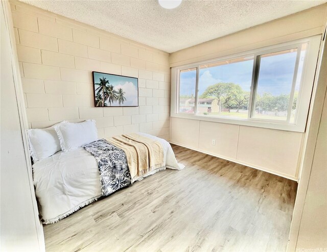 85-114 Ala Walua St Unit F, Waianae, HI 96792 - bedroom with a textured ceiling and wood finished floors