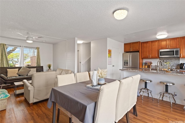 92-1327 Panana St Unit 49, Kapolei, HI 96707 - dining area with a textured ceiling and light wood-type flooring