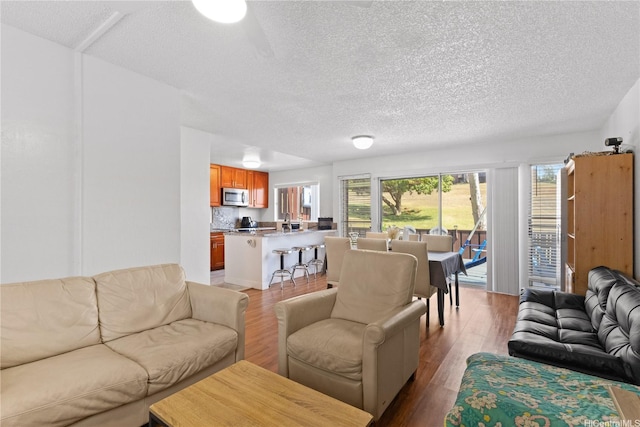 92-1327 Panana St Unit 49, Kapolei, HI 96707 - living room featuring wood finished floors and a textured ceiling