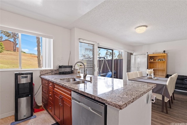 92-1327 Panana St Unit 49, Kapolei, HI 96707 - kitchen featuring dishwasher, a sink, light stone counters, a textured ceiling, and light wood-style flooring