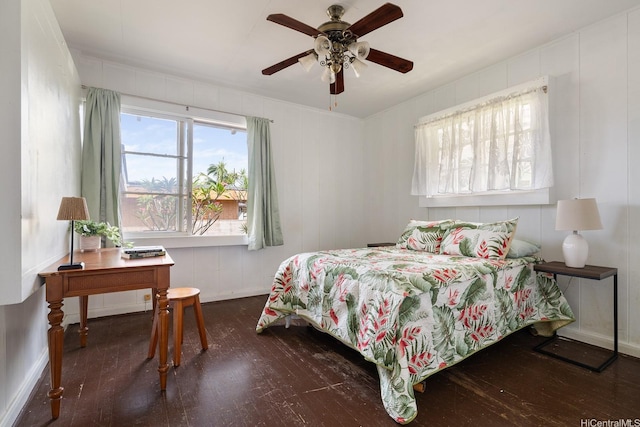 bedroom with ceiling fan, baseboards, and wood finished floors