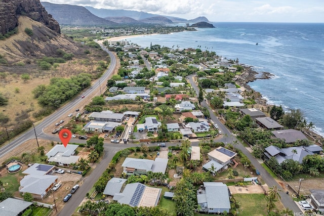 drone / aerial view featuring a residential view and a water and mountain view