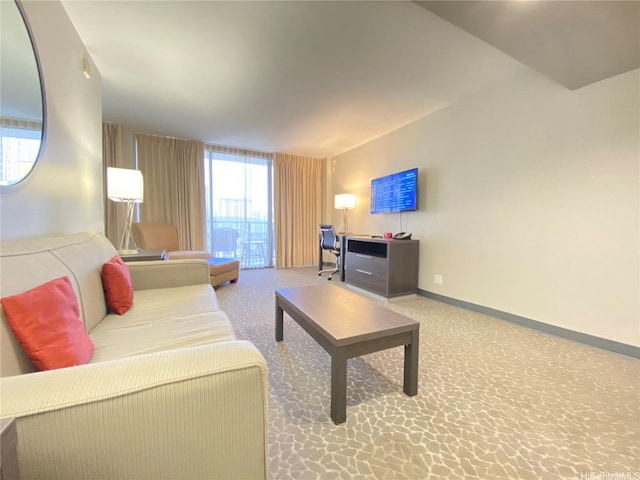 carpeted living room with baseboards