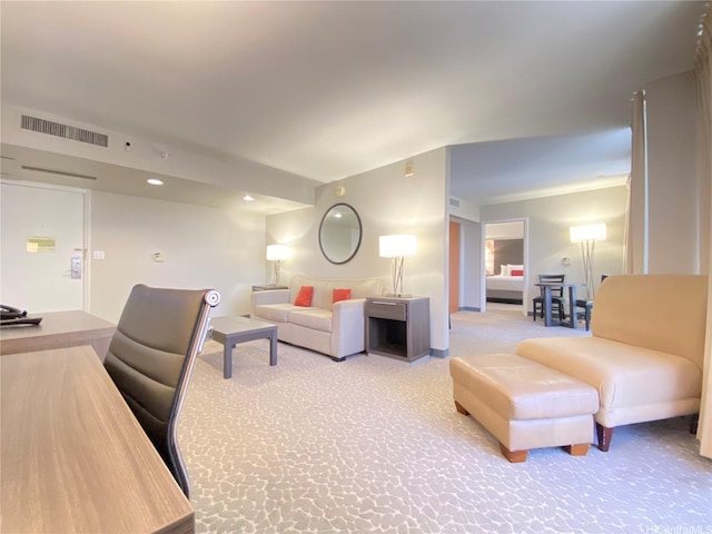 living room featuring light carpet, visible vents, and recessed lighting