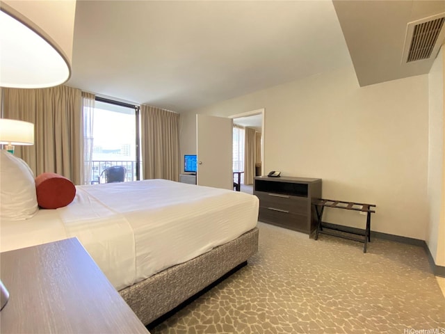 bedroom featuring baseboards, multiple windows, visible vents, and carpet