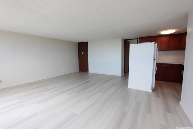 98-288 Kaonohi St Unit 3802, Aiea, HI 96701 - unfurnished living room with light wood finished floors, a textured ceiling, and baseboards