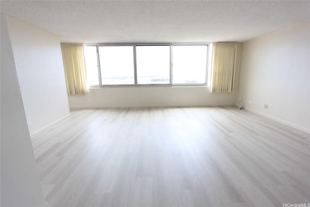 98-288 Kaonohi St Unit 3802, Aiea, HI 96701 - unfurnished room with light wood-type flooring, baseboards, and a textured ceiling