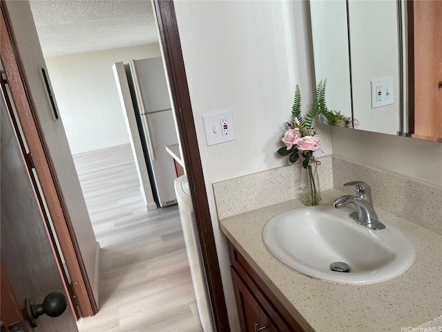 98-288 Kaonohi St Unit 3802, Aiea, HI 96701 - bathroom with wood finished floors, vanity, and a textured ceiling