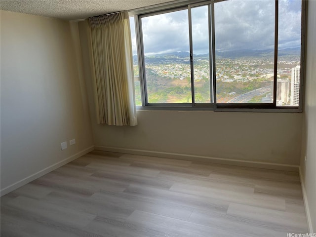 98-288 Kaonohi St Unit 3802, Aiea, HI 96701 - unfurnished room featuring light wood-type flooring and a textured ceiling