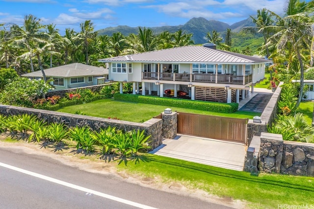 53-926 Kamehameha Hwy, Hauula, HI 96717 - rear view of house with a standing seam roof, a mountain view, a yard, and metal roof