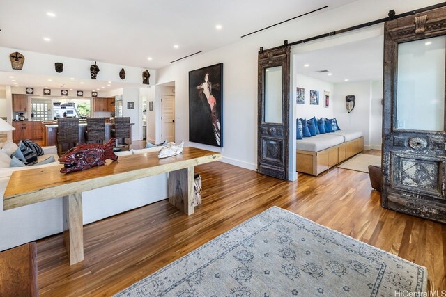 53-926 Kamehameha Hwy, Hauula, HI 96717 - living room featuring light wood-type flooring, a barn door, baseboards, and recessed lighting