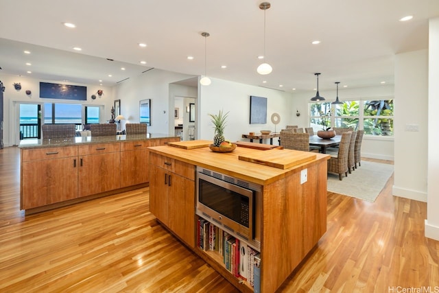 53-926 Kamehameha Hwy, Hauula, HI 96717 - kitchen featuring pendant lighting, a spacious island, stainless steel microwave, wood counters, and light wood-style flooring