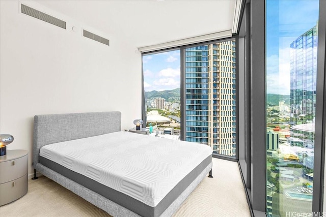 1000 Auahi St Unit 2410, Honolulu, HI 96814 - bedroom with light carpet, a view of city, expansive windows, and multiple windows