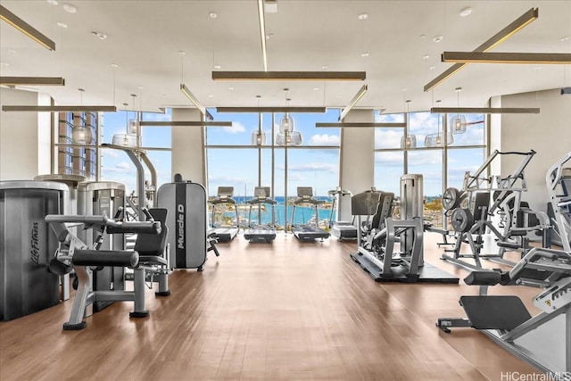 1000 Auahi St Unit 2410, Honolulu, HI 96814 - exercise room with floor to ceiling windows, healthy amount of natural light, and wood finished floors