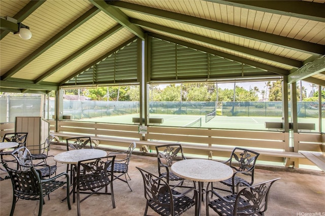 view of home's community with fence and a tennis court