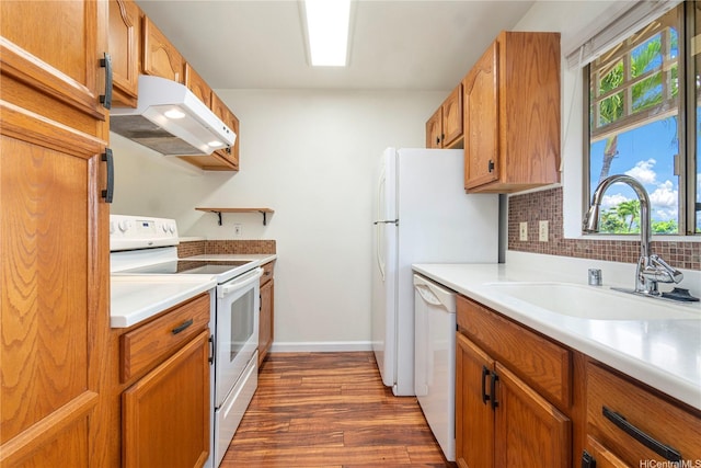 94-608 Lumiaina St Unit S201, Waipahu, HI 96797 - kitchen with white appliances, dark wood-style floors, under cabinet range hood, a sink, and backsplash