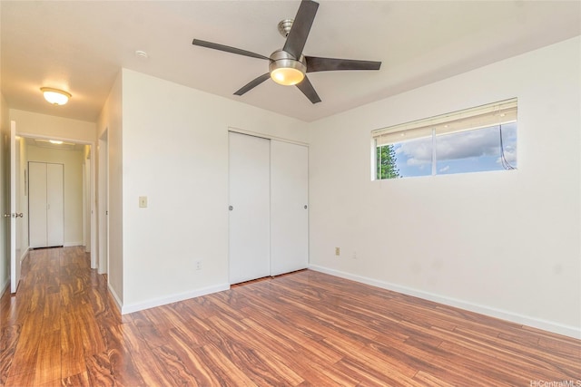 94-608 Lumiaina St Unit S201, Waipahu, HI 96797 - unfurnished bedroom featuring baseboards, ceiling fan, a closet, and wood finished floors