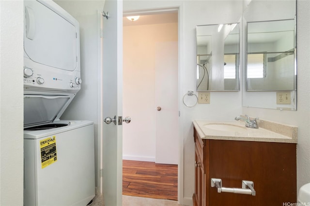 94-608 Lumiaina St Unit S201, Waipahu, HI 96797 - bathroom featuring stacked washing maching and dryer, vanity, and wood finished floors