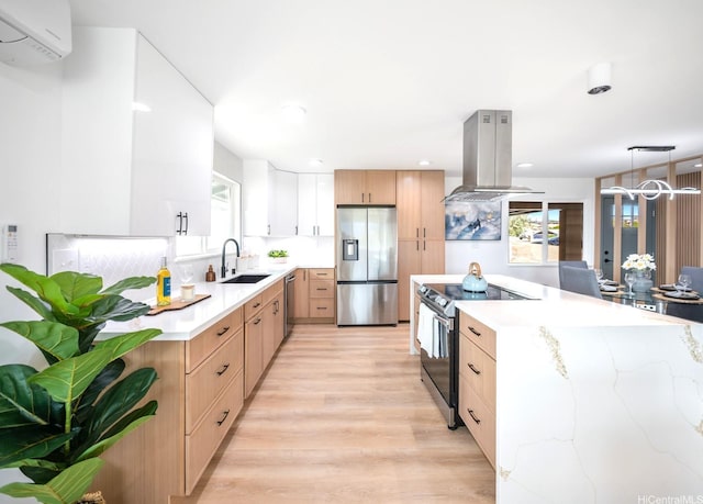 1129 Ala Aloalo St, Honolulu, HI 96818 - kitchen featuring island exhaust hood, stainless steel appliances, a wall unit AC, a sink, and light wood-type flooring