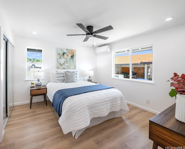 1129 Ala Aloalo St, Honolulu, HI 96818 - bedroom with baseboards, light wood finished floors, multiple windows, and a wall mounted AC